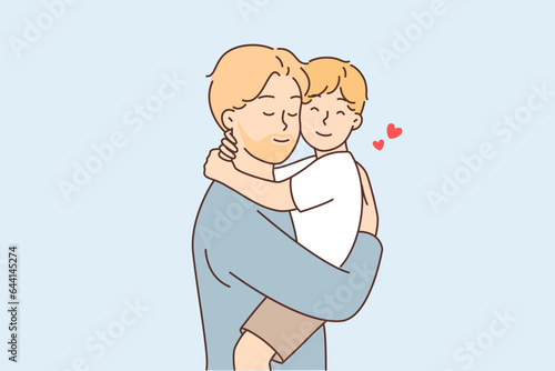 Happy father holds and hugs little son after long separation or returning from vacation