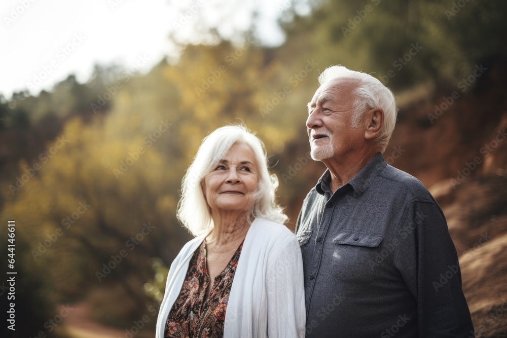 shot of a senior couple standing together in nature shot of a senior couple standing together in nature