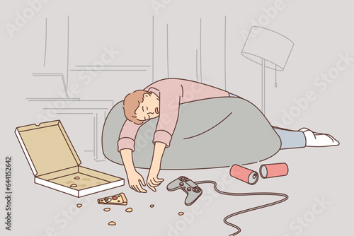 Drunk man sleeps in dirty apartment near joystick with scattered pizza and beer cans