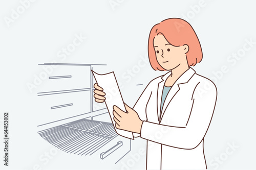 Woman doctor stands in archive of hospital and takes out patient questionnaire from closet