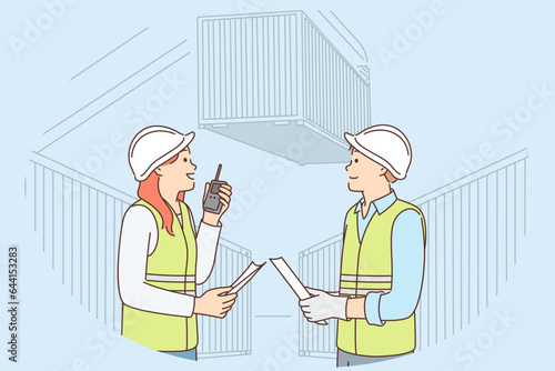 Man and woman work in container port and use walkie-talkie to negotiate with logisticians