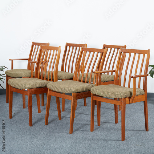 Set of Mid-Century Modern tweed upholstered dining chairs. Vintage teak furniture. Interior photograph.