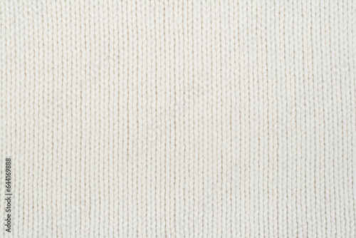 Sweater or scarf fabric texture large knitting. Knitted jersey background with a relief pattern. Wool hand- machine, handmade.