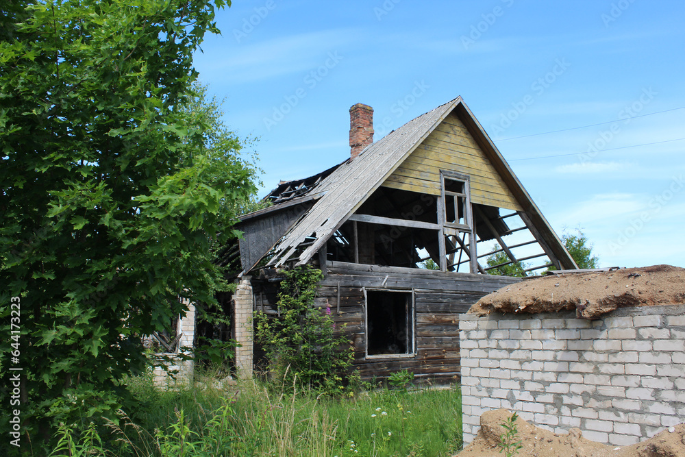Abandoned home in with shed with white bricks in front of it in Eglaine, Latvia Abandoned home in with shed with white bricks in front of it in Eglaine, Latvia