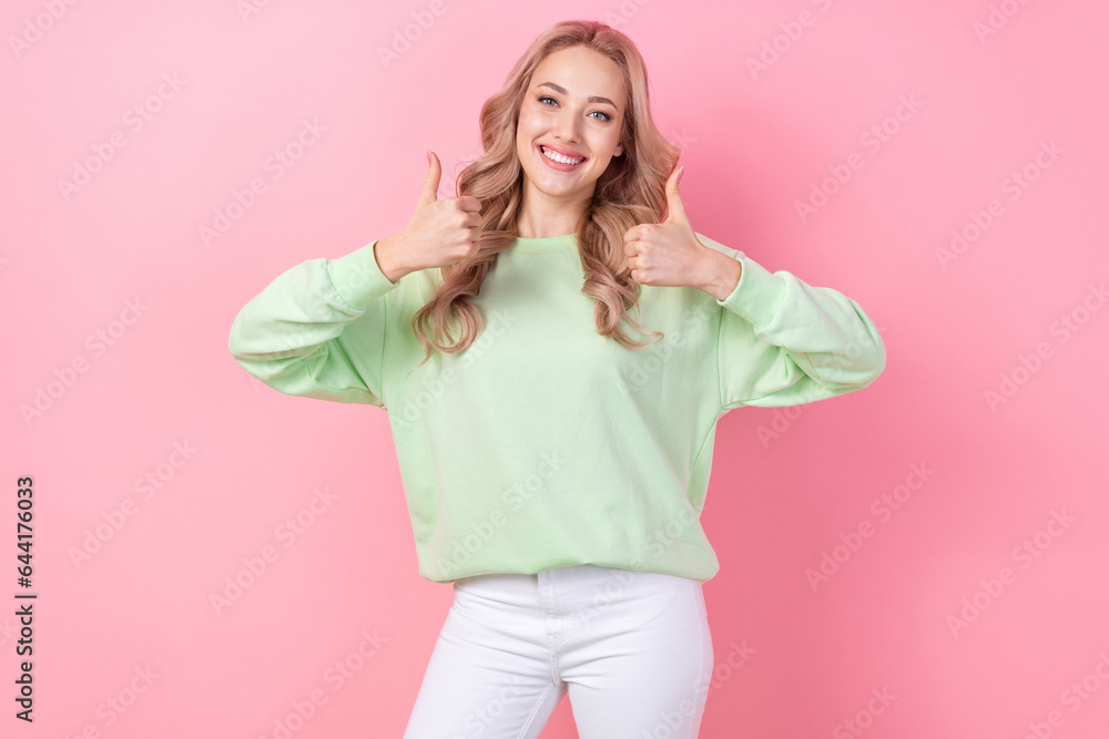 Photo of optimistic girl showing thumb up symbol good job cool recommendation double feedback sale outfit isolated on pink color background Photo of optimistic girl showing thumb up symbol good job cool recommendation double feedback sale outfit isolated on pink color background