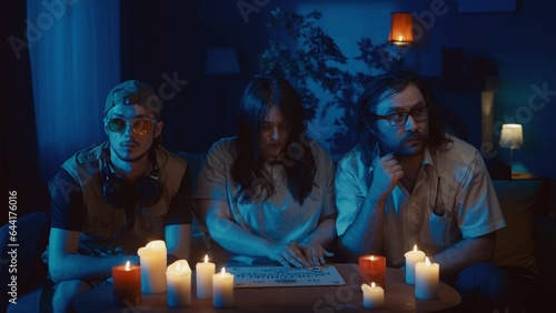 Canvas Print Shot capturing a group of people having an ouija board session, seance