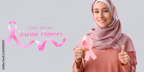 Muslim woman with pink ribb...