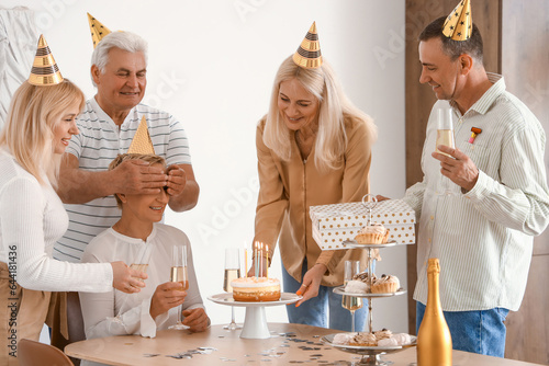 Mature people with cake cel...