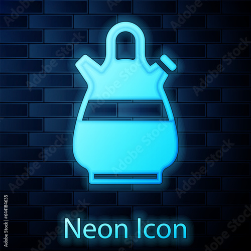 Glowing neon Sangria pitcher icon isolated on brick wall background. Traditional spanish drink. Vector