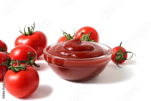 On a white background there is a plate with ketchup and tomatoes.