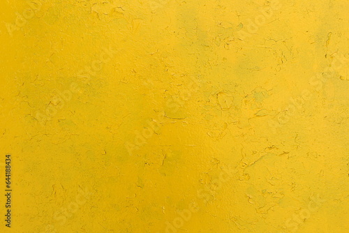 Texture of a painted yellow concrete wall.