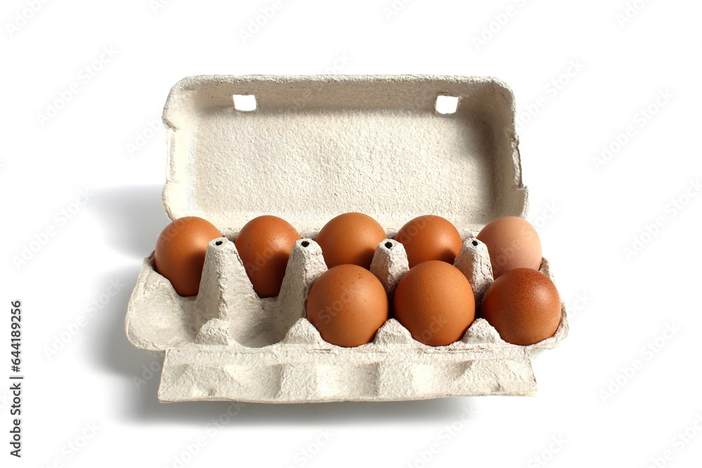 A tray with brown chicken eggs stands on a white background.