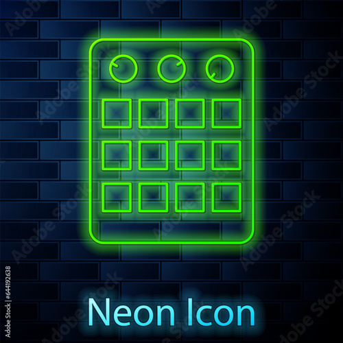 Glowing neon line Drum machine icon isolated on brick wall background. Musical equipment. Vector