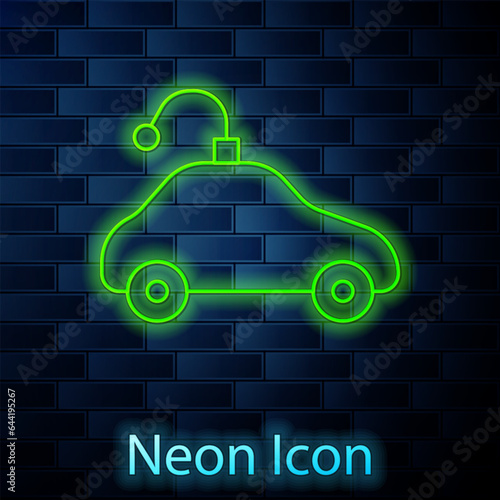 Glowing neon line Radio controlled car toy icon isolated on brick wall background. Control remote car toy. Vector