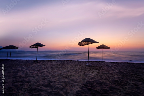 Fototapeta Naklejka Na Ścianę i Meble -  An empty beach landscape photographed with a long exposure technique at sunset.  