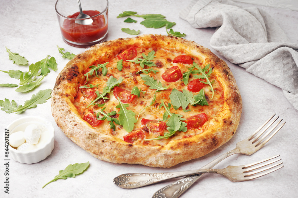 Tasty pizza Margarita with arugula and bowl of mozzarella on white table Tasty pizza Margarita with arugula and bowl of mozzarella on white table