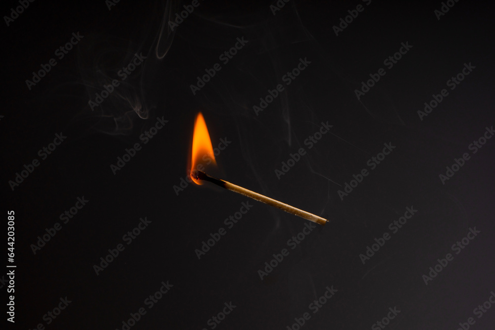 Lit falling match on a black background. Lit falling match on a black background.