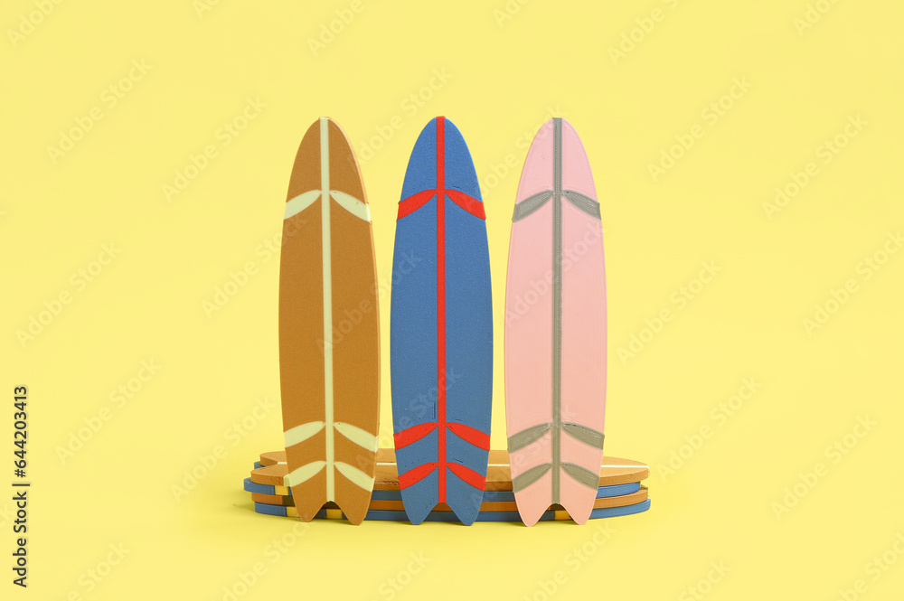 Different mini surfboards on yellow background Different mini surfboards on yellow background