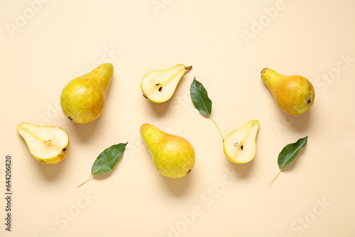 Ripe pears and leaves on yellow background photo