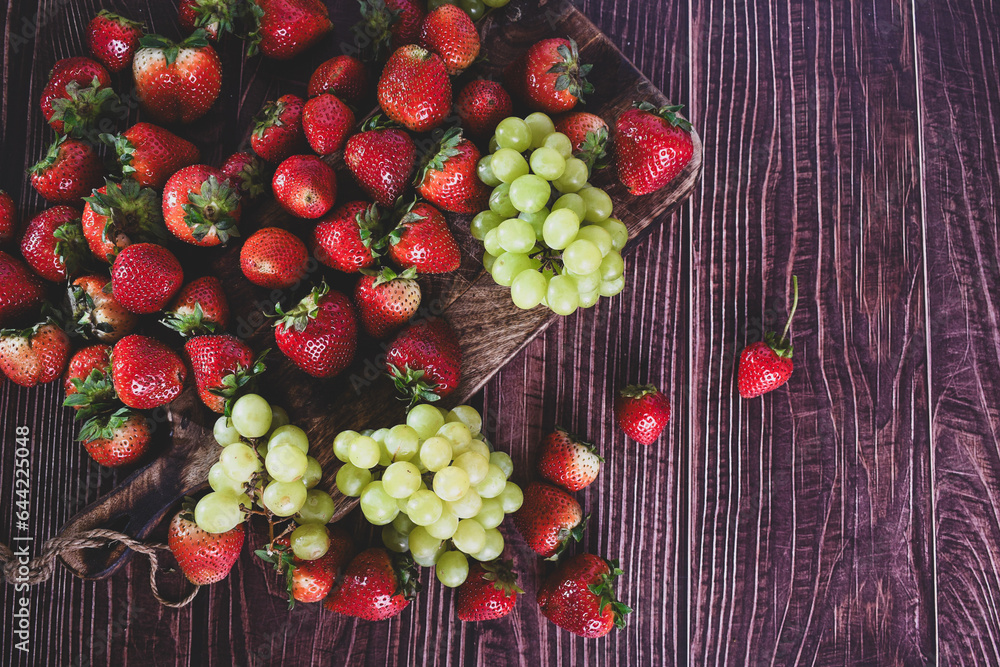 ripe freshly harvested organic strawberries and grapes ready to eat. ripe freshly harvested organic strawberries and grapes ready to eat.