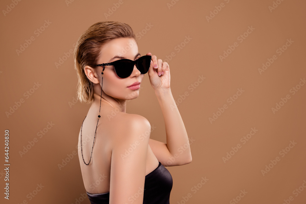 Fototapeta premium Photo of lady boss touch sunglass guard president wife on vip secret corporate party isolated beige background