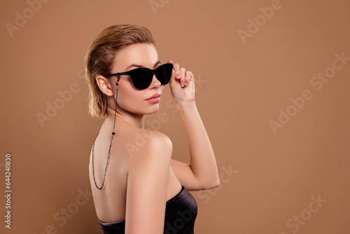 Photo of lady boss touch sunglass guard president wife on vip secret corporate party isolated beige background