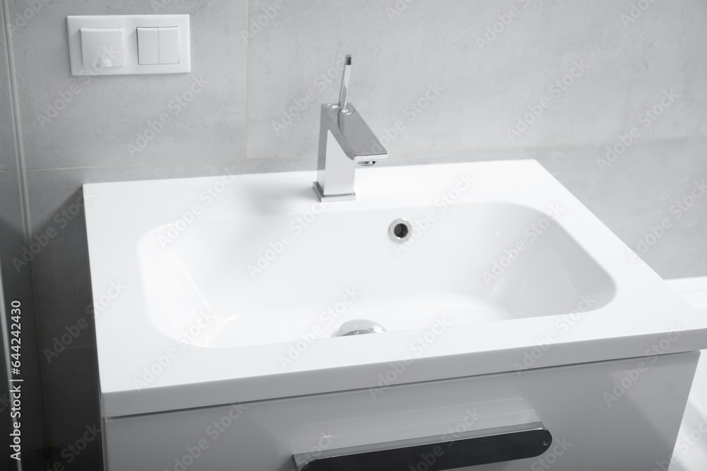 Washbasin and chrome faucet in the bathroom Washbasin and chrome faucet in the bathroom