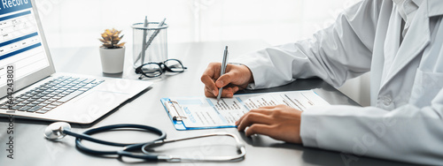 Doctor carefully review detailed medical report with laptop and diagnosing illness for effective healthcare treatment plan for patient in doctor office. Professional medical evaluation. Neoteric