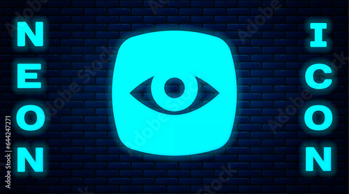 Glowing neon Security camera icon isolated on brick wall background. Vector