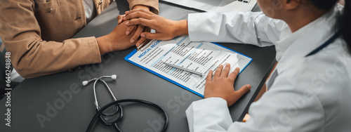 Foto Doctor show medical diagnosis report and providing compassionate healthcare consultation while holding young patient hand for being supportive and professional in doctor clinic office