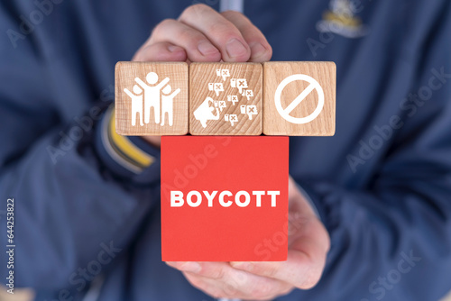 Man holding colorful blocks and sees inscription: BOYCOTT. Concept of boycott. Announcement of protest, demonstration. photo