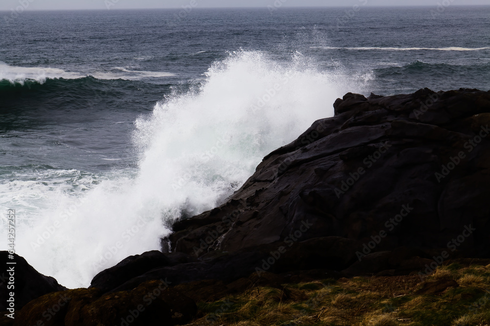 Ocean Wave Crashing Into Volcanic Rock Shore
