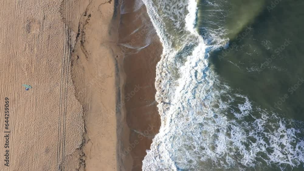 Aerial View Top Down of a Person Walking into the Atlantic Ocean in Virginia Beach with Waves Crashing Aerial View Top Down of a Person Walking into the Atlantic Ocean in Virginia Beach with Waves Crashing