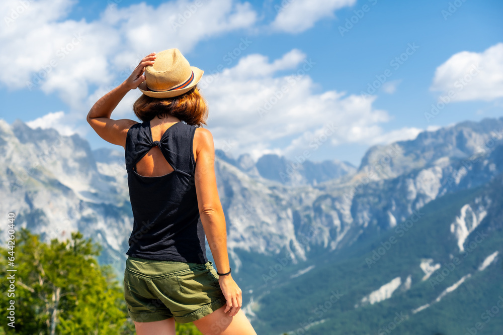 A tourist woman on the valley mountain peaks of Theth national park, Albania. Albanian Alps