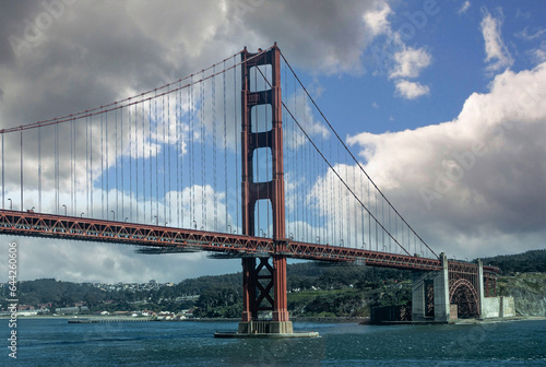 Photography San Francisco, CA, USA - July 13, 2023: Ocean side, south landing and tower of Golden Gate bridge under blue cloudscape