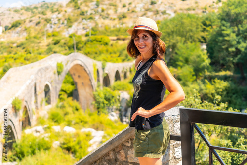 A tourist woman on the Ottoman Old Mes bridge near Shkoder. Albania, Europe. Ura e Kadiut photo