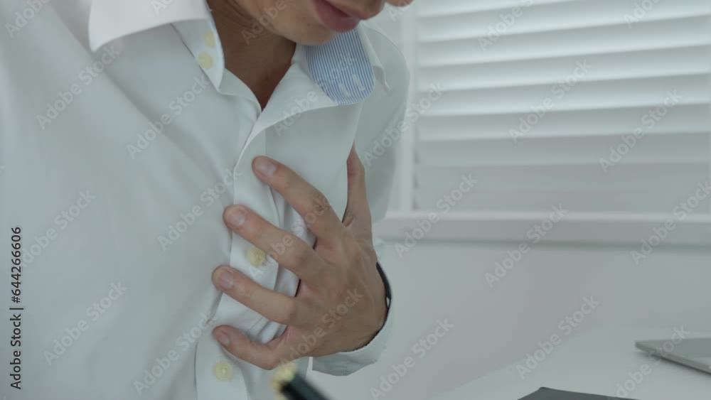 hand hold chest with heart attack symptoms, asian man working hard have