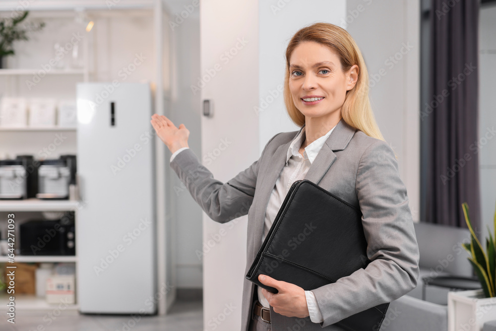 Happy real estate agent with leather portfolio indoors Happy real estate agent with leather portfolio indoors