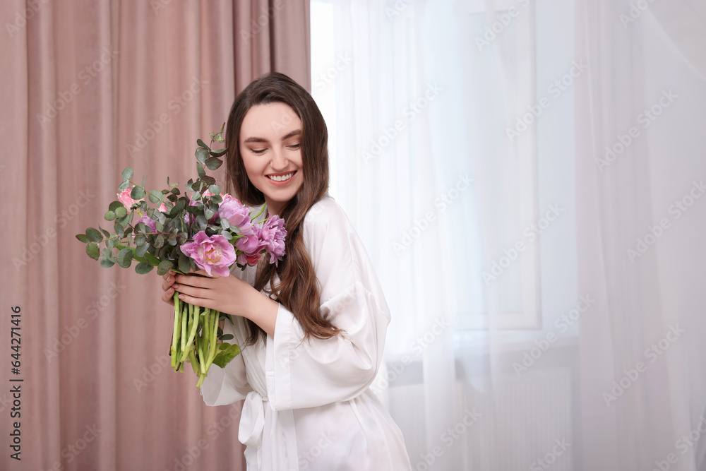 Beautiful happy young woman with bouquet of flowers indoors Beautiful happy young woman with bouquet of flowers indoors