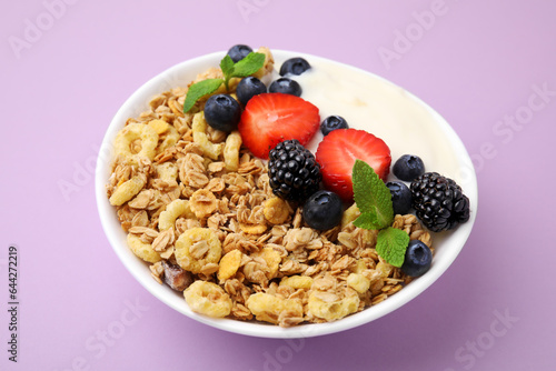 Tasty oatmeal, yogurt and fresh berries in bowl on lilac background, closeup. Healthy breakfast