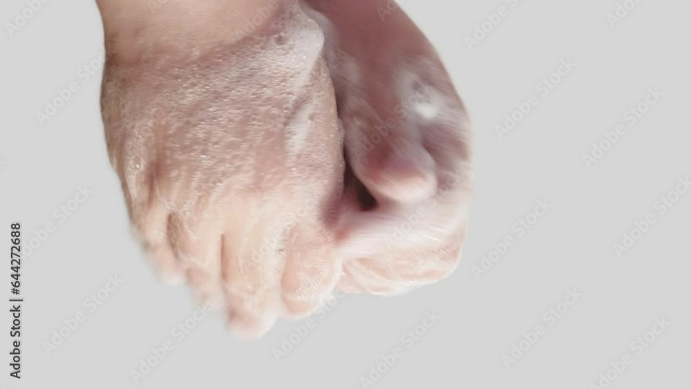 Vertical video. Antibacterial hygiene. Virus prevention. Woman cleansing hands skin with sanitizing soap foam washing off bacteria isolated on white background. Vertical video. Antibacterial hygiene. Virus prevention. Woman cleansing hands skin with sanitizing soap foam washing off bacteria isolated on white background.