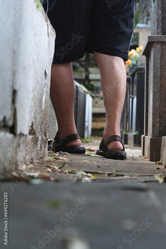 A person is seen walking among the tombs of Campo Santo Cemetery, in the city of Salvador, Bahia.