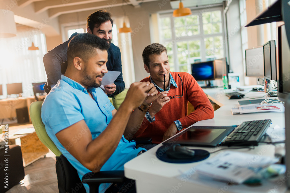 Young and diverse group of people working together in a startup company office Young and diverse group of people working together in a startup company office