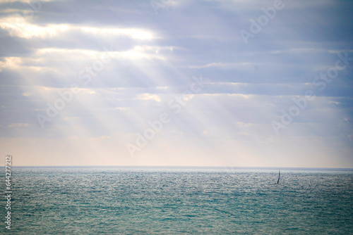 sailboat in rays of sunshine 