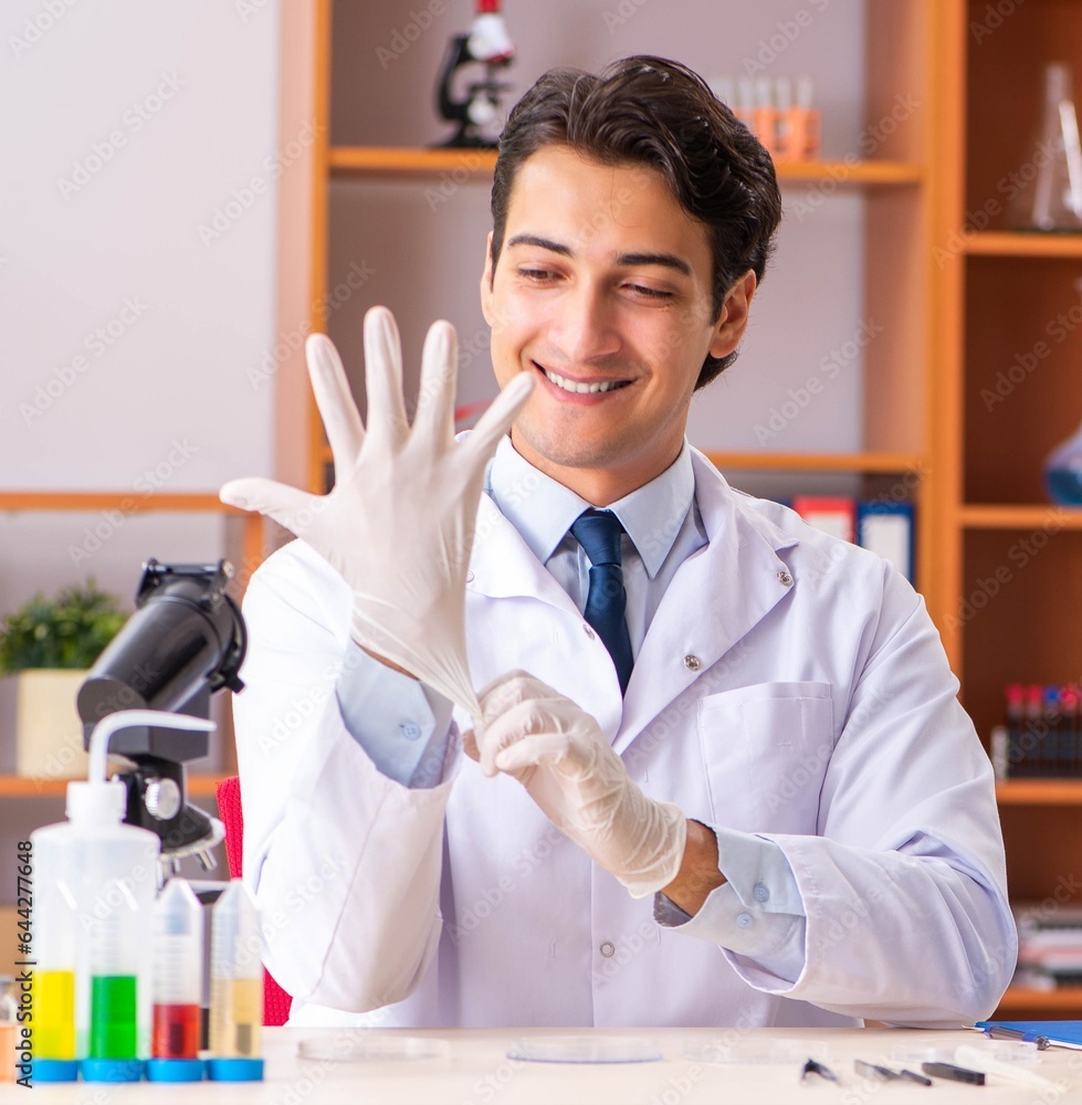 Young handsome biochemist working in the lab Young handsome biochemist working in the lab