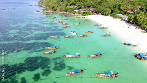 Koh Lipe Island Southern Thailand with turqouse colored ocean and white sandy beach, longtail boats in the ocean from above with a drone photo