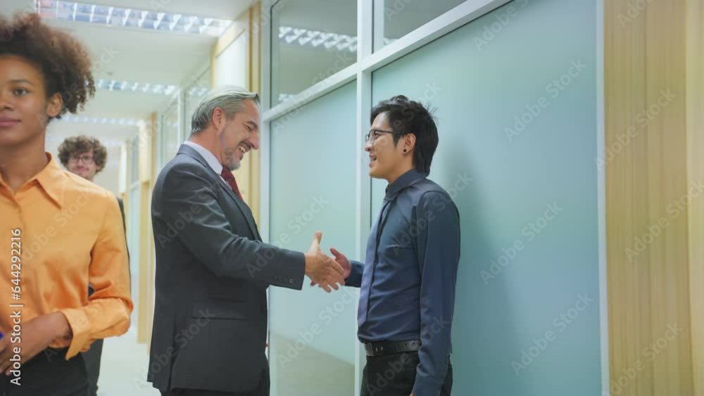 Caucasian businessman making a handshake together while stand in office. Caucasian businessman making a handshake together while stand in office.