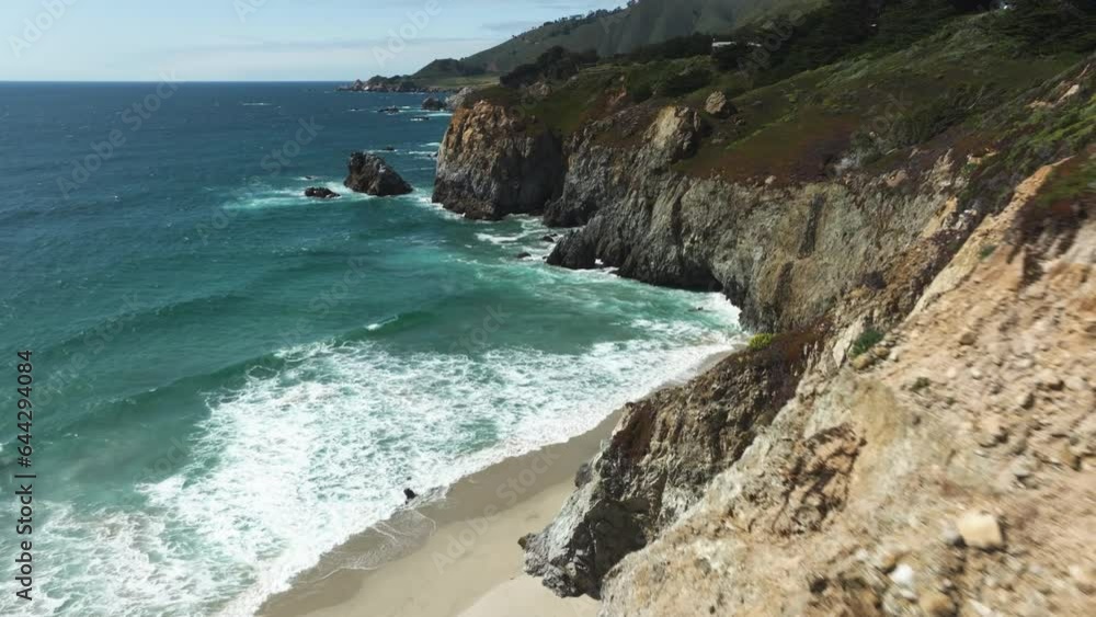 Aerial view tilting over a beach and waves on the coast of Big Sur, California, USA Aerial view tilting over a beach and waves on the coast of Big Sur, California, USA