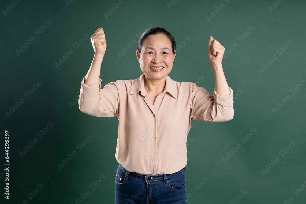 Gangang middle-aged Asian female portrait posing on blue background