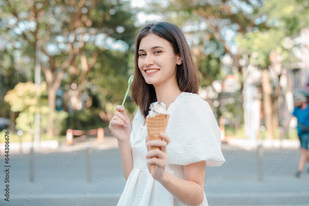 Portrait of happy young woman with delicious ice cream in waffle cone outdoors. Portrait of happy young woman with delicious ice cream in waffle cone outdoors.